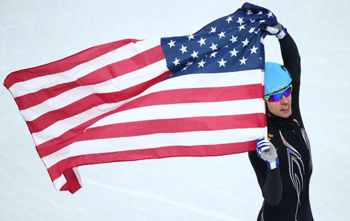 American Jordan Malone celebrates his team's silver-medal finish in the 5,000-meter short-track speedskating relay at the Sochi Winter Olympic Games on Friday.