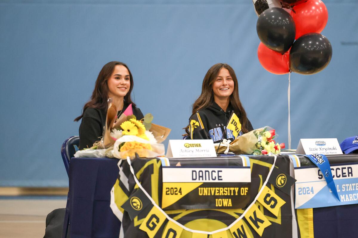 Marina's Ashley Morris, left, and Izzie Krysinski are all smiles during a signing day ceremony on May 10.