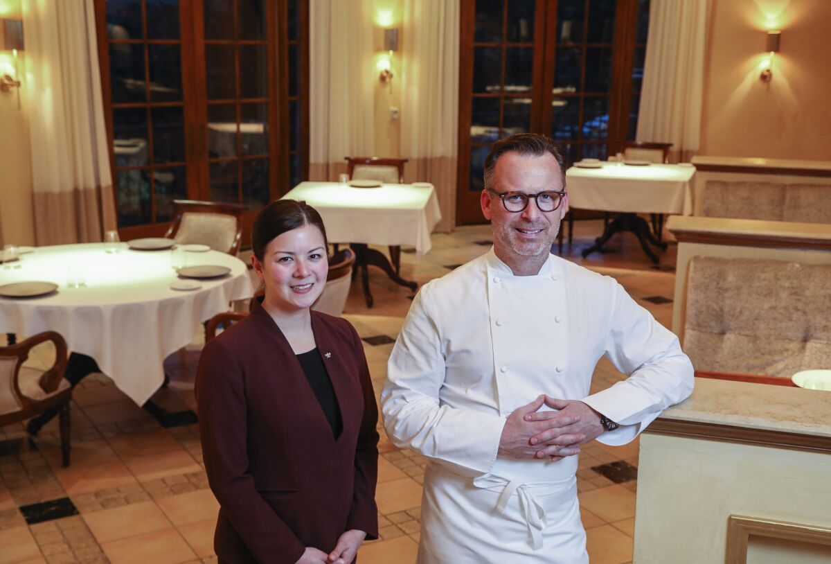 New wine director Victoria O'Bryan, left, and founding executive chef William Bradley pose for photos in the newly remodeled dining area at Addison, San Diego County's only Michelin-starred restaurant, in Carmel Valley.