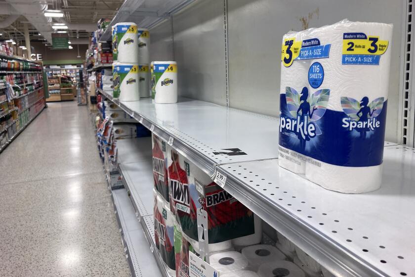 Near empty shelves are seen in the paper goods section of a supermarket Thursday, Jan. 13, 2022, in Orlando, Fla. (AP Photo/John Raoux)