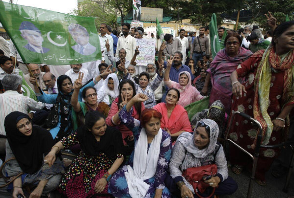 Supporters of Pakistan's former president, Pervez Musharraf, rally in Karachi after a court decision against the ex-military leader. Musharraf was later arrested.