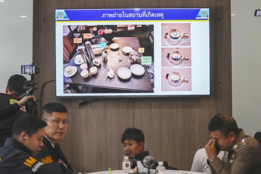 Thai police display pictures of evidence during a press conference at Lumpini police station in Bangkok, Thailand, Wednesday, July 17, 2024. The chief of the Thai police forensic division said Wednesday that police have found traces of cyanide in the cups of six people found dead in a central Bangkok luxury hotel. (AP Photo/Sakchai Lalit)