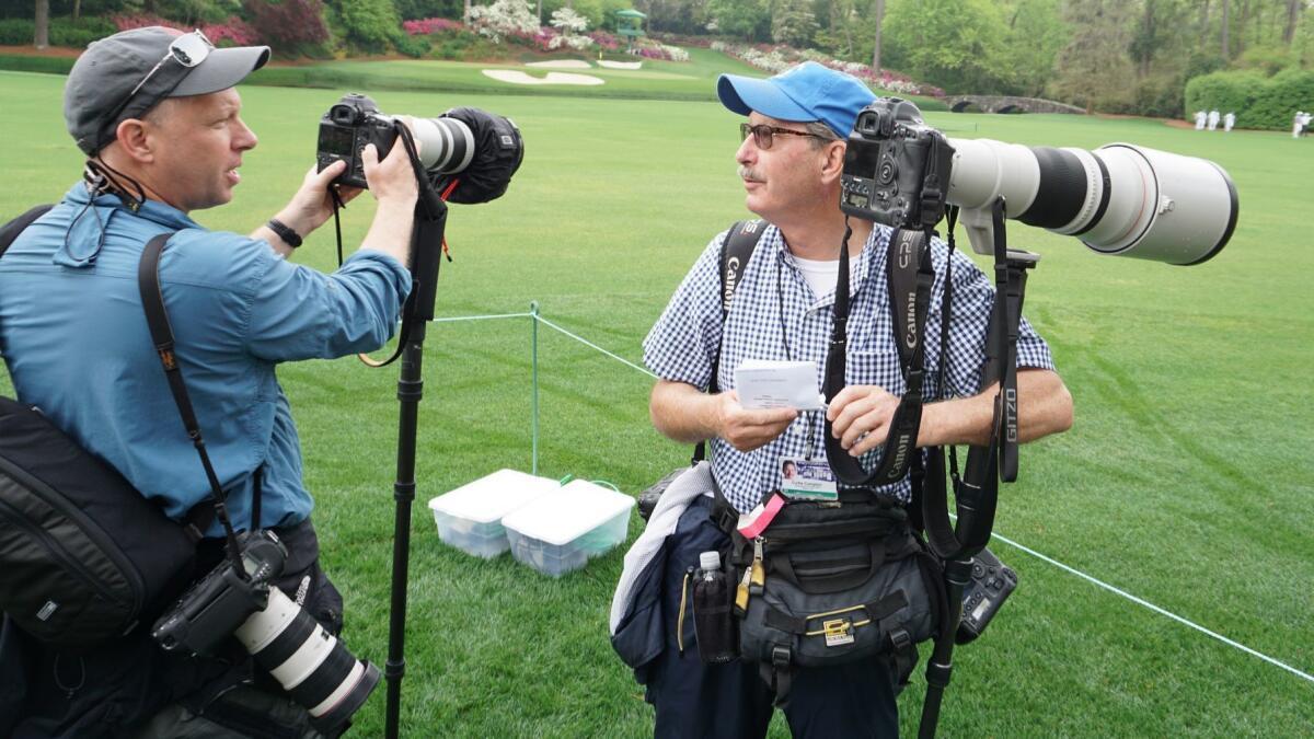 Reuters photographer Brian Snyder and Atlanta Journal-Constitution photographer Curtis Compton talk at Augusta National.