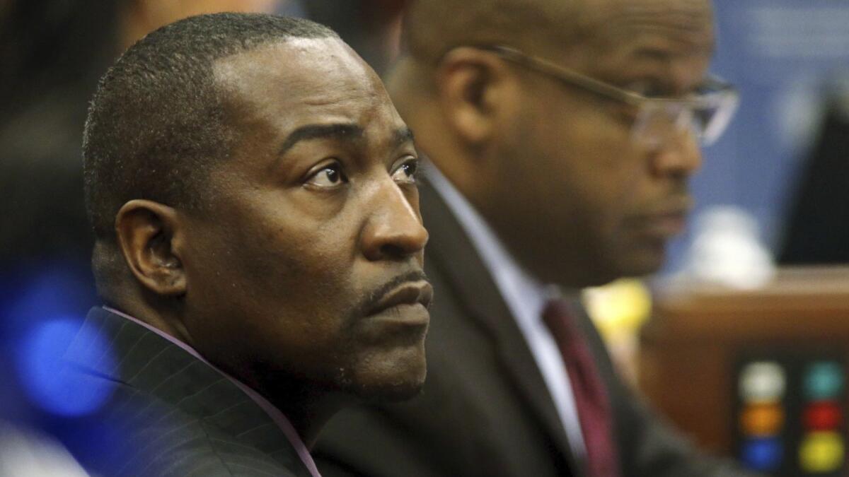 Tyrone Thompson, left, sits on the Nevada Assembly floor with Assembly Majority Leader William Horne in 2013.