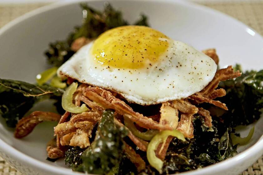 Fried pig ears and crispy kale are topped with a fried egg at the Purple Pig. Recipe