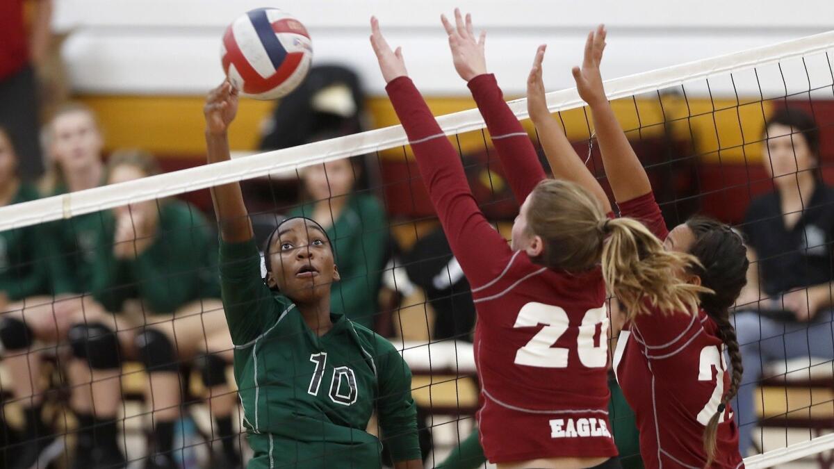 Costa Mesa High's Tarah Harmon (10) scores against Estancia during the first set of an Orange Coast League match on Tuesday.