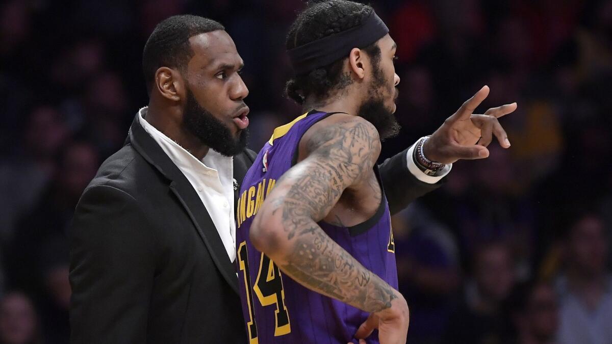 Injured forward LeBron James, left, talks with Lakers teammate Brandon Ingram during the second half of a game against the New York Knicks earlier this month.