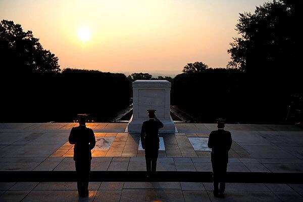 The changing of the guard takes place shortly after sunrise at the Tomb of the Unknowns at Arlington National Cemetery in Arlington, Va., where Sen. Edward M. Kennedy will be buried alongside his slain brothers.