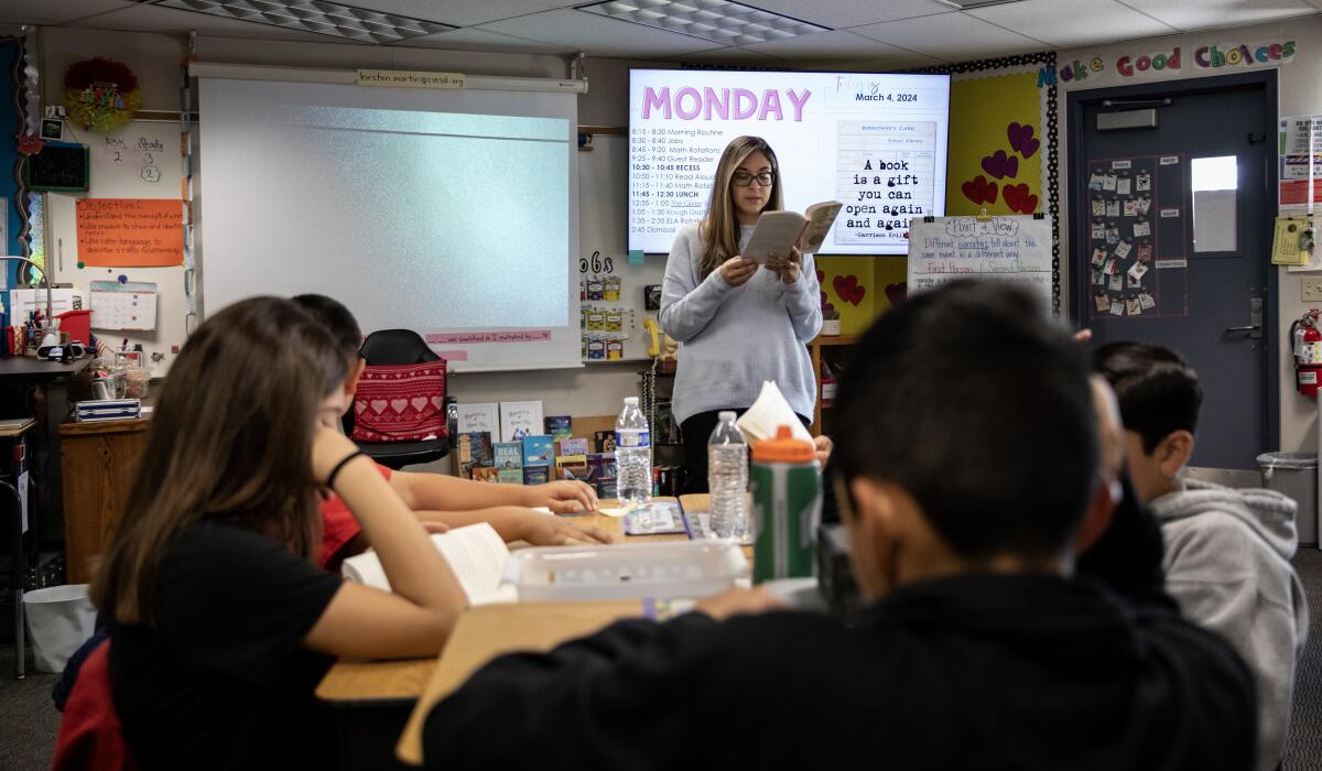 Carolina Abrego reads "The Giver" to sixth graders at Rohr Elementary School.