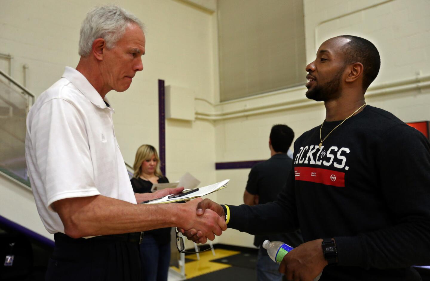 Lakers general manager Mitch Kupchak greets former Terps star Dez Wells after a May workout.