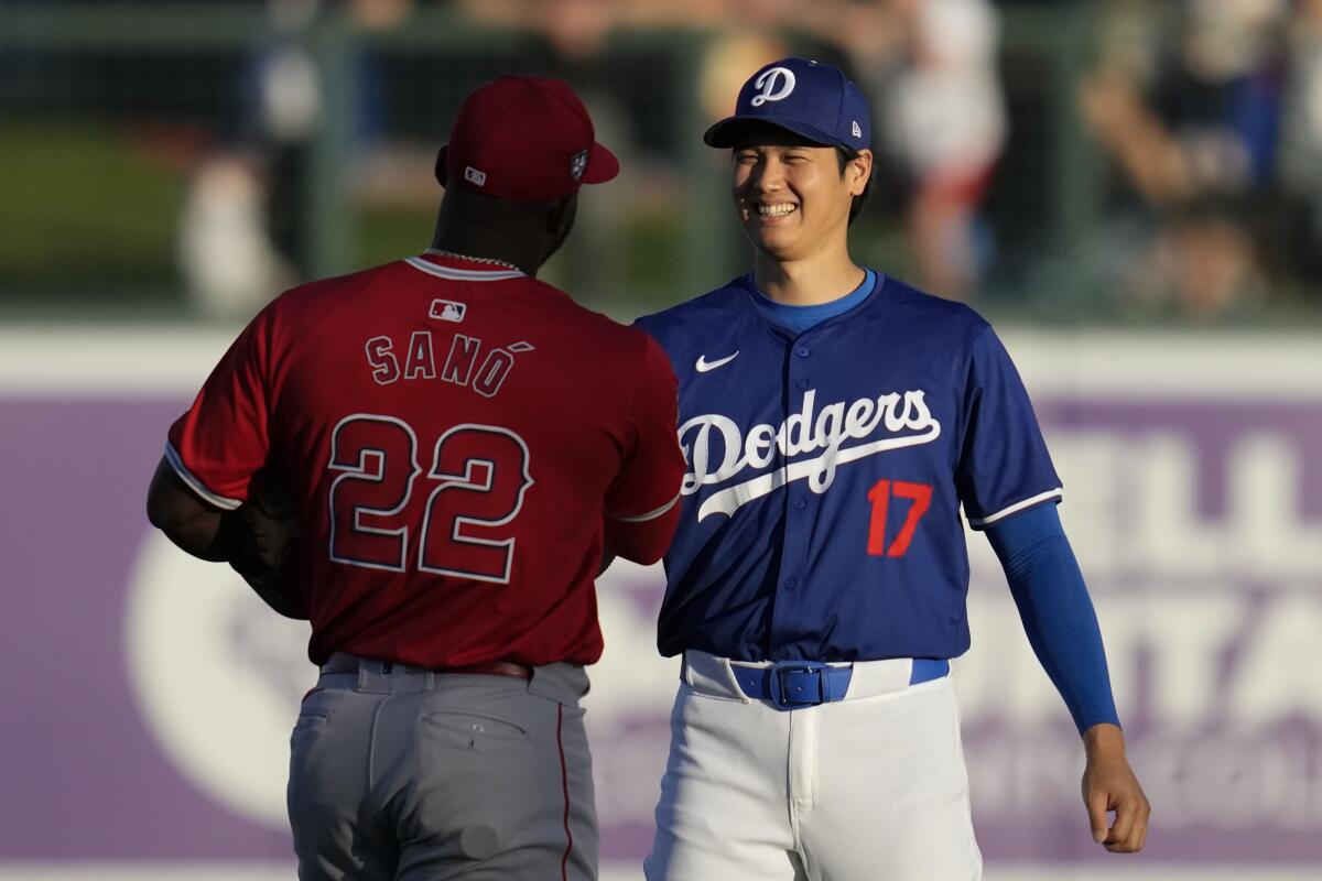 Shohei Ohtani greets Angels third baseman Miguel Sanó before Tuesday's game.