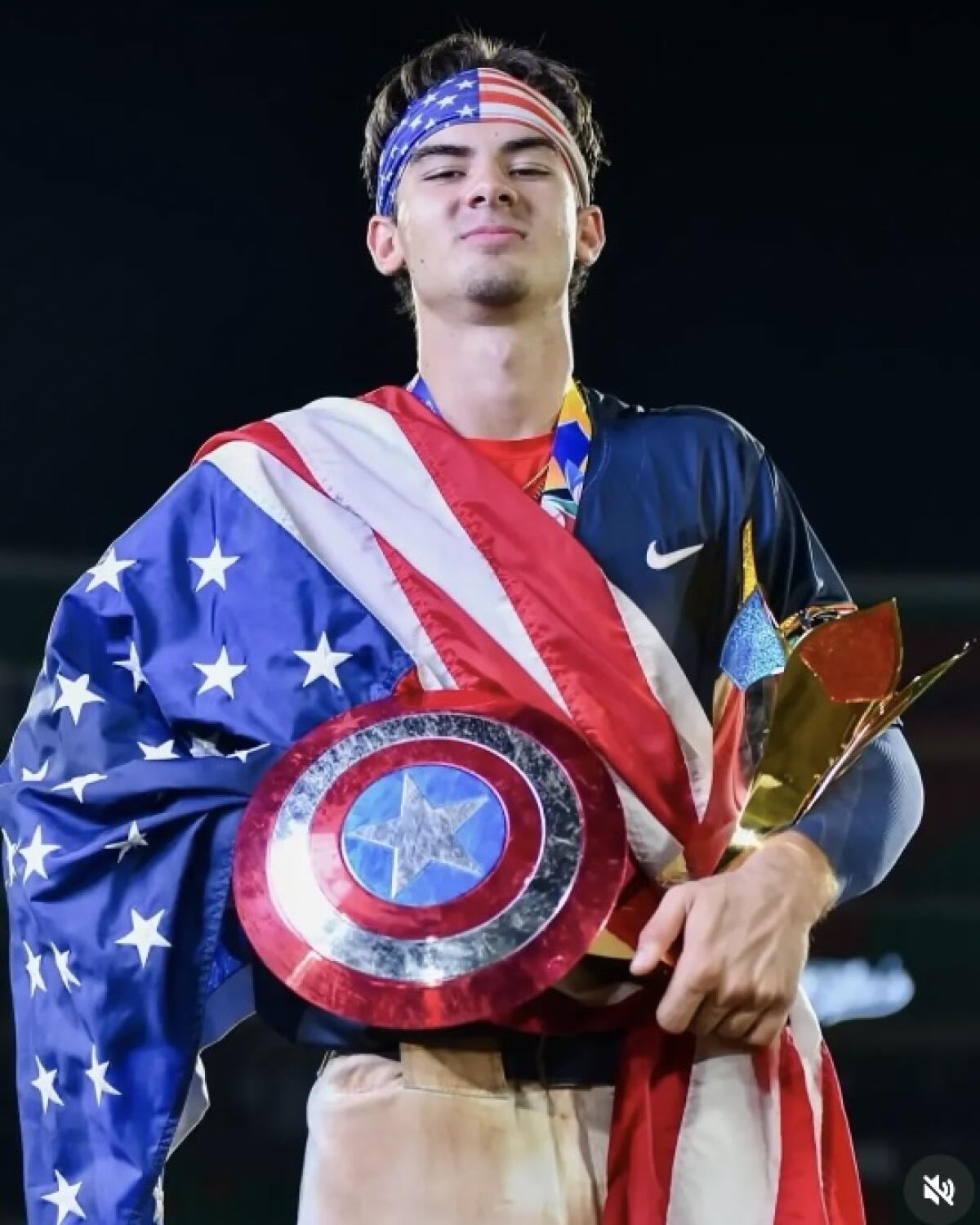Matti Di Maggio, a sophomore at Dos Pueblos High, poses for a photo with a U.S. flag draped over his right shoulder.