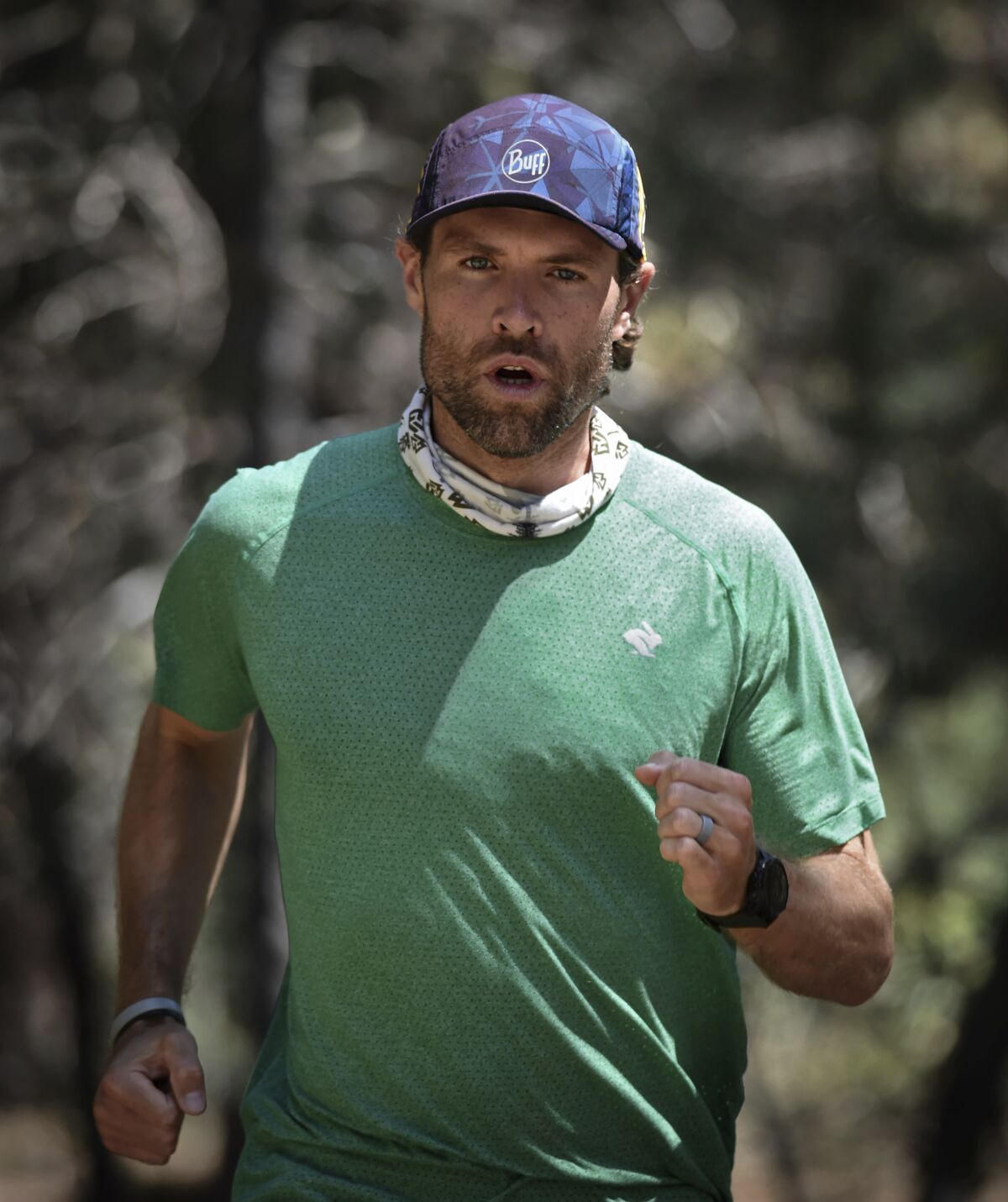 Professional runner Adam Kimble runs at Lake Tahoe on July 29, 2020. On July 18, the Tahoe City resident crushed the previous record for the fastest known time for a supported run on the Tahoe Rim Trail, a roughly 170-mile (273-kilometer) path that circumnavigates Lake Tahoe. He completed the feat in 37 hours, 12 minutes and 15 seconds, almost an hour and a half faster than the previous record. (Andy Barron/The Reno Gazette-Journal via AP)