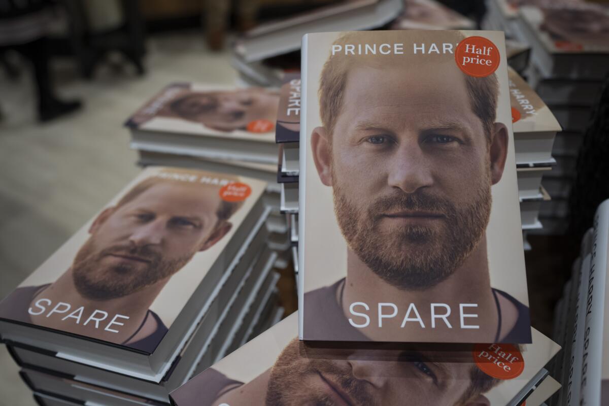 Stacks of copies of Prince Harry's memoir "Spare" at a London bookstore. Cover shows Harry with a trimmed beard