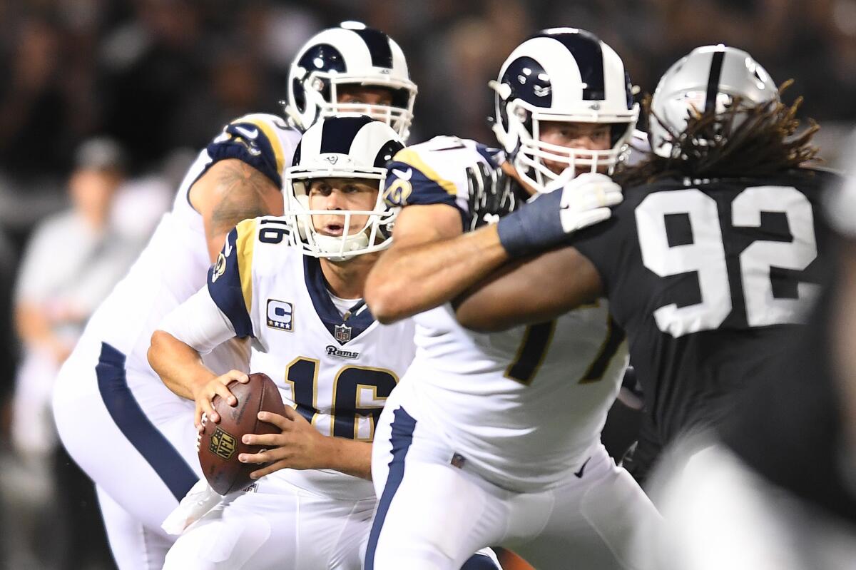 Los Angeles Rams quarterback Jared Goff scrambles against pressure from the Oakland Raiders defense.
