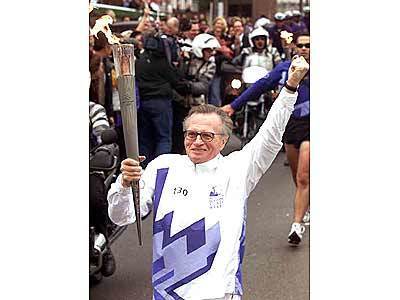 Larry King holds the Olympic torch