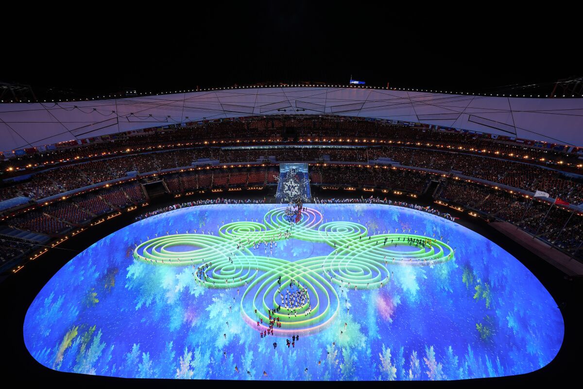 Olympic Stadium is illuminated for the 2022 Olympics closing ceremony.