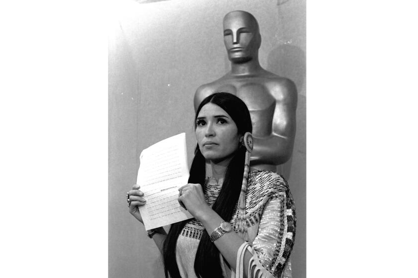 FILE - Sacheen Littlefeather appears at the Academy Awards ceremony to announce that Marlon Brando was declining his Oscar as best actor for his role in "The Godfather," on March 27, 1973. The move was meant to protest Hollywood's treatment of American Indians. Nearly 50 years later, the Academy of Motion Pictures Arts and Sciences has apologized to Littlefeather for the abuse she endured. The Academy Museum of Motion Pictures on Monday said that it will host Littlefeather, now 75, for an evening of “conversation, healing and celebration” on Sept. 17. (AP Photo, File)