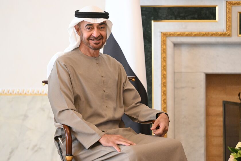 FILE - President of the United Arab Emirates Sheikh Mohamed bin Zayed Al Nahyan smiles while posing for a photo prior to his talks with Russian President Vladimir Putin during their meeting in St. Petersburg, Russia, Tuesday, Oct. 11, 2022. Sheikh Mohamed bin Zayed Al Nahyan made a surprise visit on Monday, Dec. 5, 2022, to Qatar as it is hosting the World Cup — his first since leading a yearslong four-nation boycott of Doha over a political dispute that poisoned regional relations. (Pavel Bednyakov, Sputnik, Kremlin Pool Photo via AP, File)