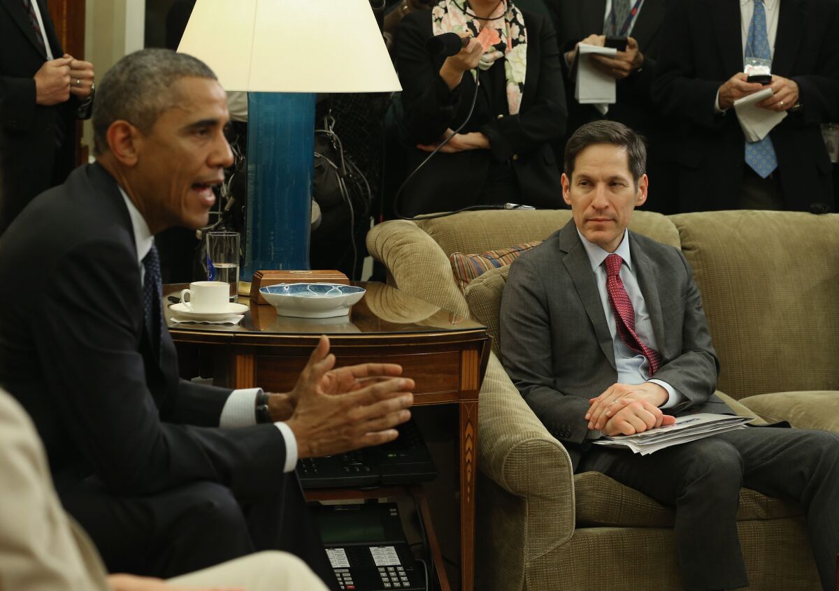 President Obama, alongside the CDC's Tom Frieden, speaks to the media about the fight against the Ebola virus during a meeting with his Ebola Response Team in the Oval Office.