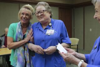 Nurse Alyce Budde, left, and auxillary volunteer Melanie Van Horn celebrate together Wednesday at Tri-City Medical Center after Van Horn announced starting a nusing scholarship fund in Buddes name. At right is Scholarship Chairman of the Auxillary Scholarship Commitee Connie Jones who accepted the proposal from Van Horn. photo by Bill Wechter