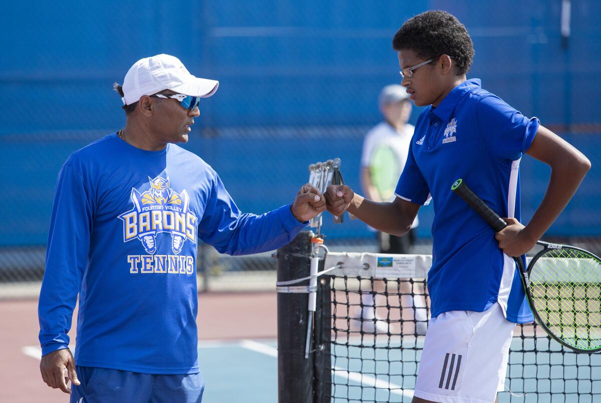 Fountain Valley High coach Harshul Patel, left, gives Malik Thiaw a fist-bump during the first round of the CIF Southern Section Division 1 playoffs against Beverly Hills on May 1, 2019.