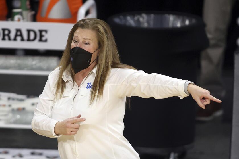 UCLA head coach Cori Close instructs her team during the second half of an NCAA college basketball game.