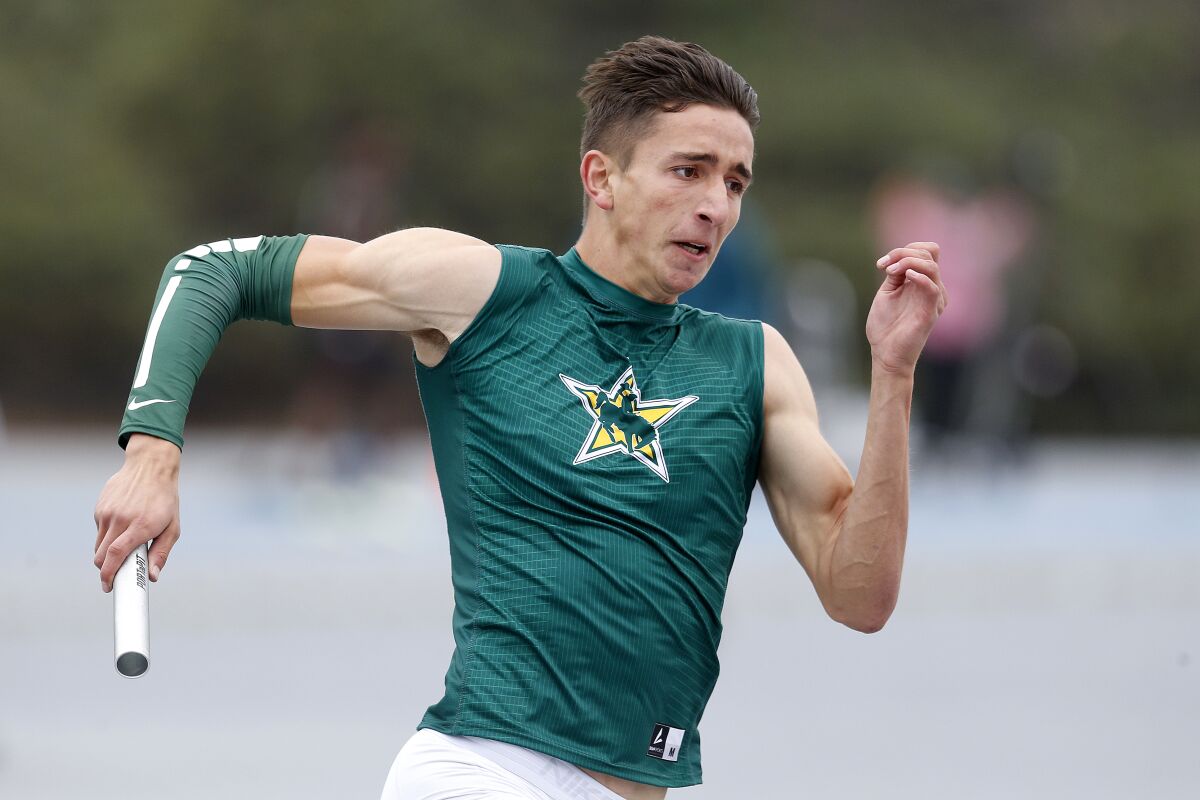 Cajon High senior Seth Johnson competes in the third leg of the boys' 100-meter relay.