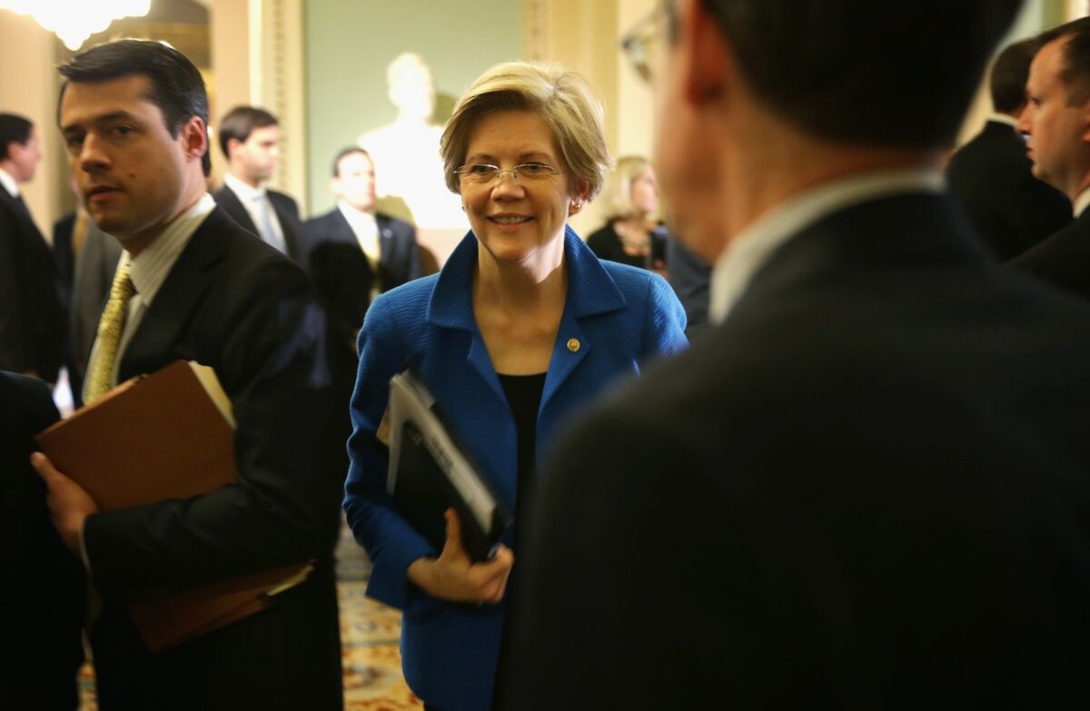 Sen. Elizabeth Warren (D-Mass.), center, walks towards the Senate Chamber after a policy luncheon on Capitol Hill.