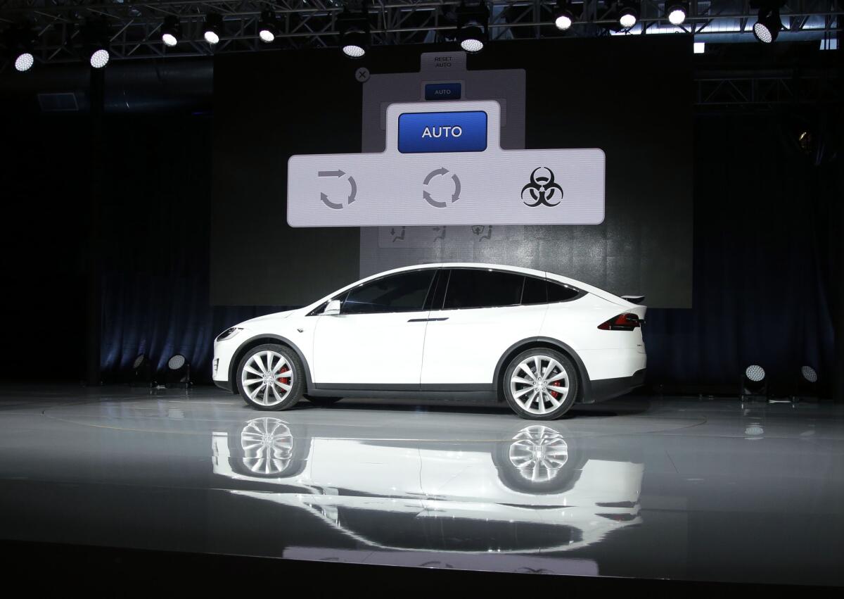 A slide displayed during Elon Musk's Tesla presentation Sept. 29 shows an interface with a button for "bioweapon defense mode."