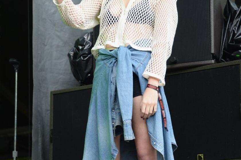 Grunge style star Sky Ferreira takes in DIIV's performance at Lollapalooza 2013 at Grant Park in Chicago.