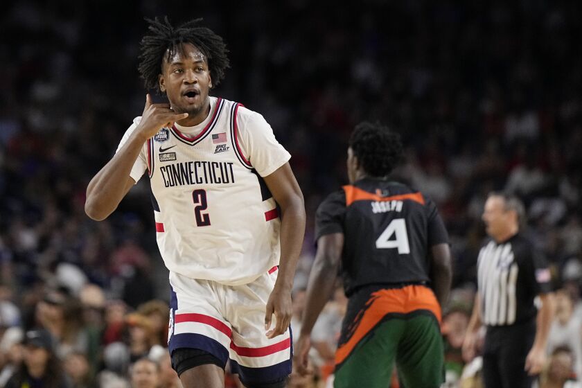 Connecticut guard Tristen Newton celebrates after scoring against Miami during the first half of a Final Four college basketball game in the NCAA Tournament on Saturday, April 1, 2023, in Houston. (AP Photo/Brynn Anderson)