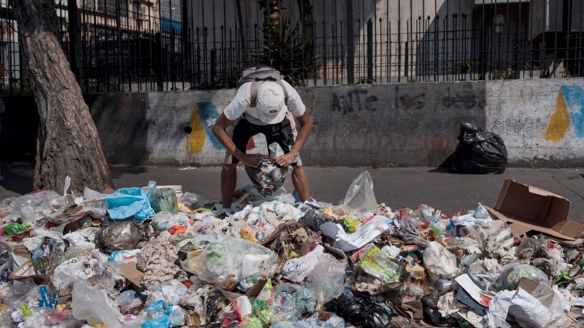 A man scavenges for food in Caracas, Venezuela, on Feb. 1, 2019.