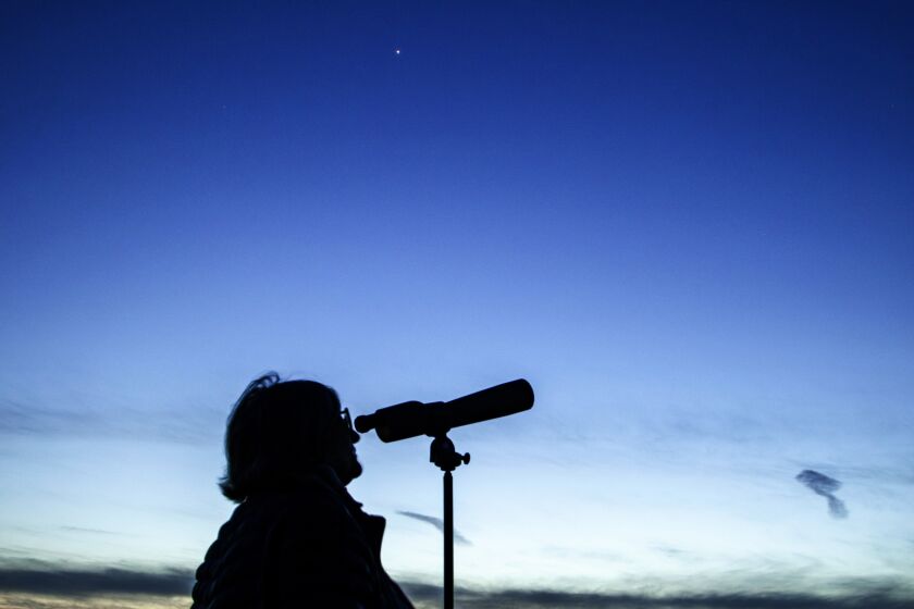 AGOURA HILLS, CA - APRIL 15, 2020 - Rachel Prado watching the stars with a telescope, Thursday, April 16, 2020 in Agoura Hills, CA. The planet Venus is on the background (Ricardo DeAratanha / Los Angeles Times)