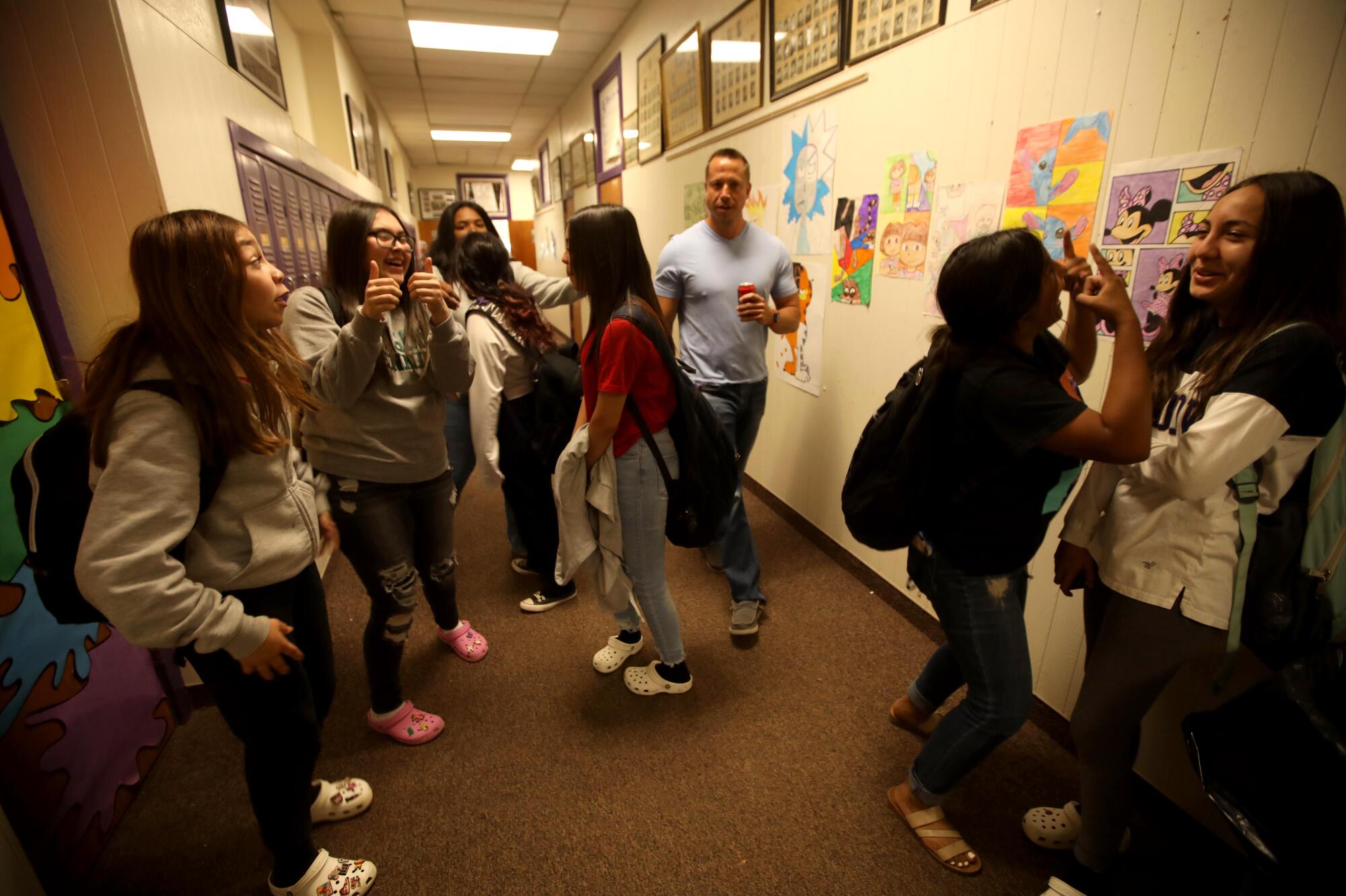 Principal Jason Atcheson greets students at Meadow School