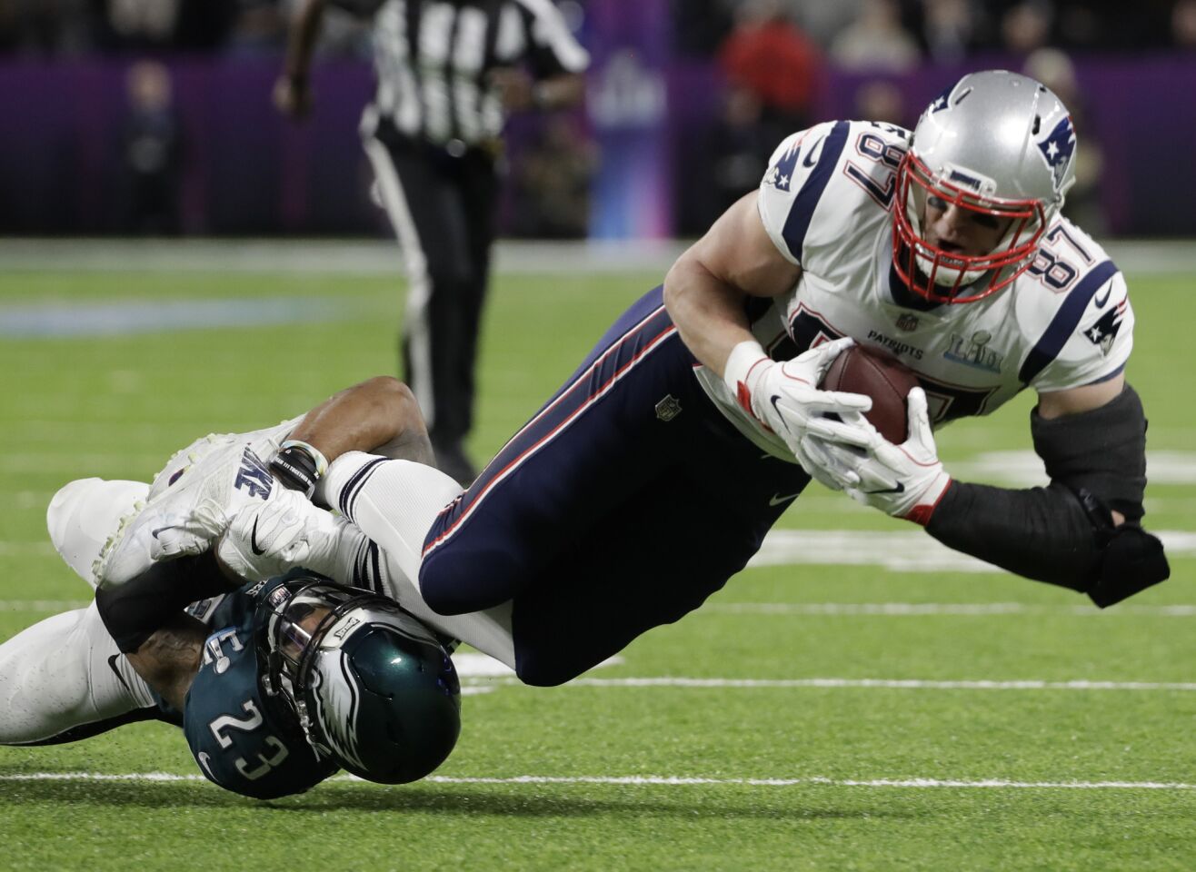 Eagles free safety Rodney McLeod tackles Patriots tight end Rob Gronkowski