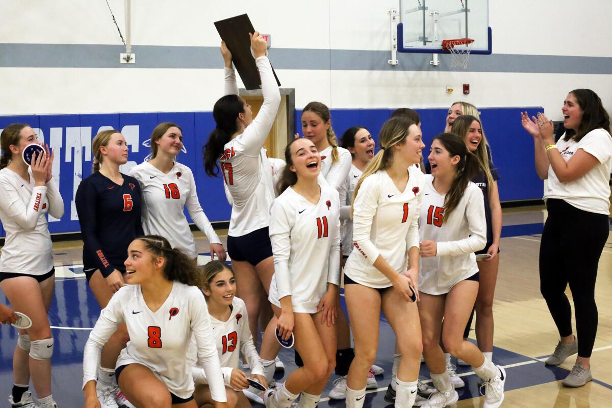 Pacifica Christian girls' varsity volleyball team hoists the CIF Southern Section Division 7 the second-place plaque.