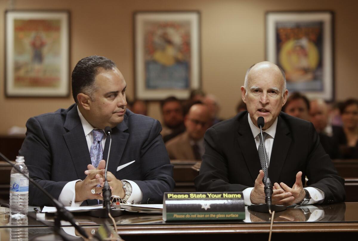 Gov. Jerry Brown discusses a proposed rainy-day-fund plan alongside John A. Perez (D-Los Angeles), then the Assembly speaker, in April.