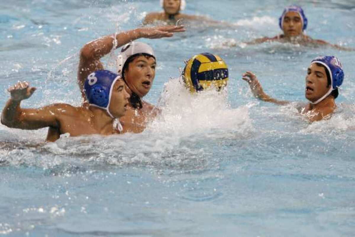 Burbank's Zach Cain, left, and Glendale's Arman Momdzhyan fight for the ball in the Pacific League championship game.