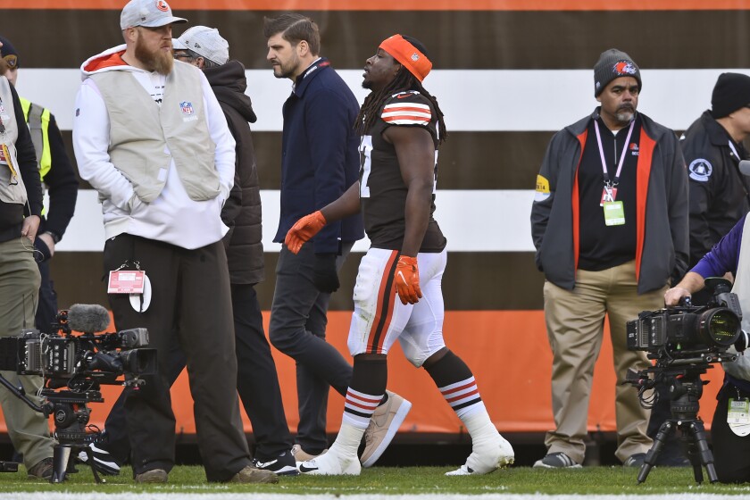 FILE - Cleveland Browns running back Kareem Hunt, center, walks off the field after an injury during the first half of an NFL football game against the Baltimore Ravens, Sunday, Dec. 12, 2021, in Cleveland. Hunt will likely miss Saturday's game against Las Vegas and could be out longer after injuring his ankle early in Cleveland's 24-22 win over Baltimore. (AP Photo/David Richard, file)