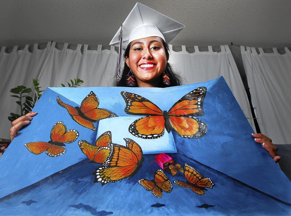Hoover graduate and artist Jasmine Trinidad with a couple pieces of artwork she created in her home in Los Angeles on Wednesday, June 4, 2014. Trinidad's artwork often involves butterflies, and with her portfolio, she earned the Jeanne Ward Foundation Scholarship and will attend Pasadena City College in the fall.
