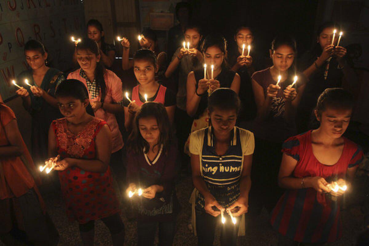 Indian schoolgirls hold candles as they pray for the speedy recovery of a 5-year-old girl who was allegedly raped in New Delhi.