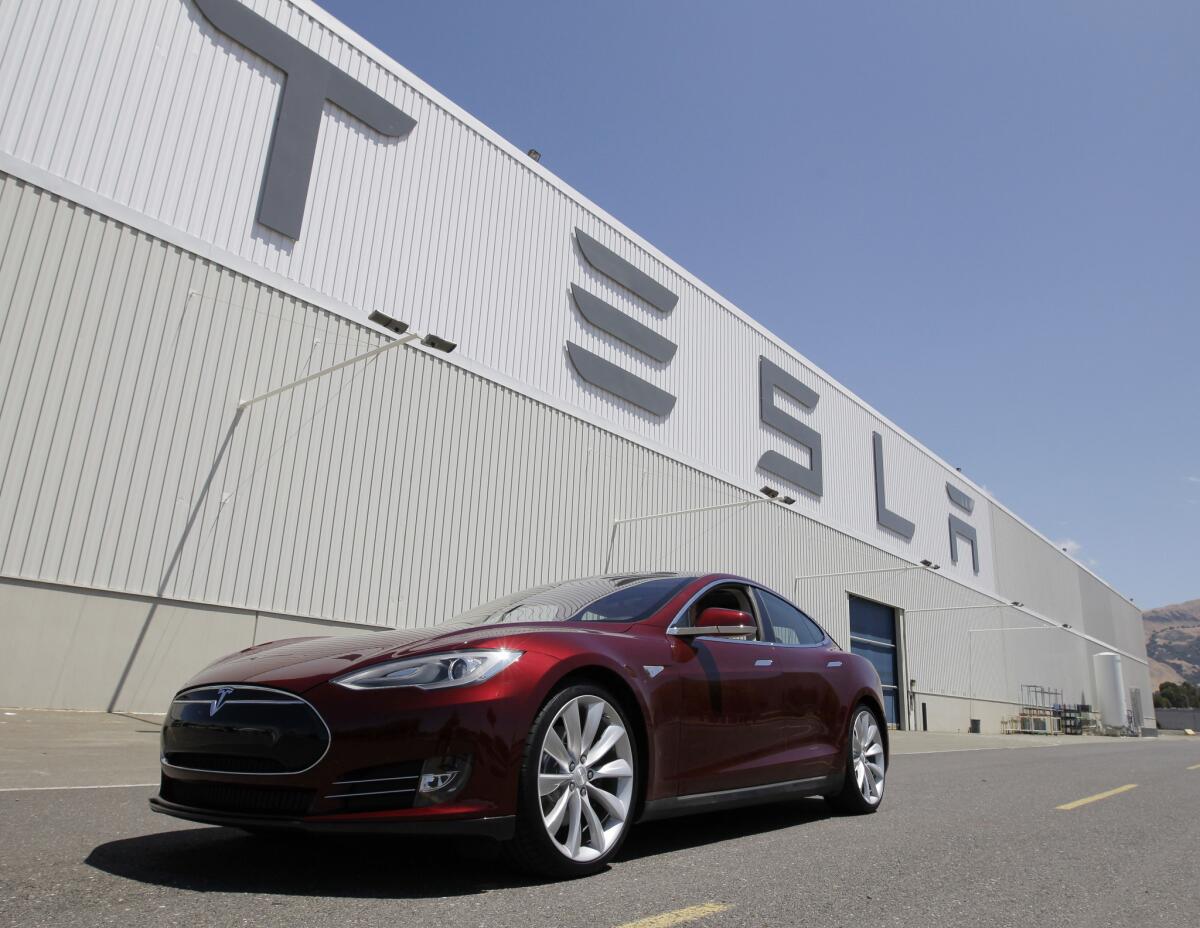 The auto research firm Edmunds.com bought a Tesla Model S and gave it a long-term test, and has published the results. This June 22, 2012 file photo shows a Tesla Model S outside the Tesla factory in Fremont, Calif.