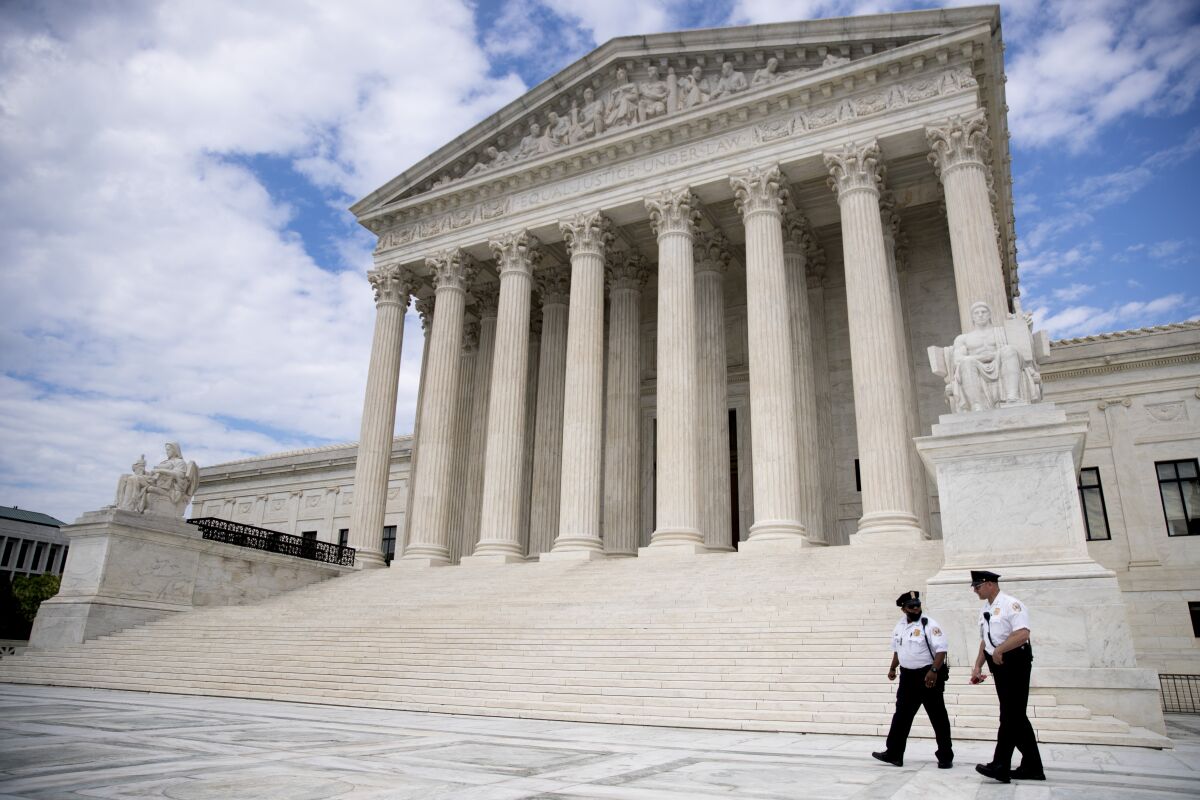 Security officers walk in front of the Supreme Court on May 14.