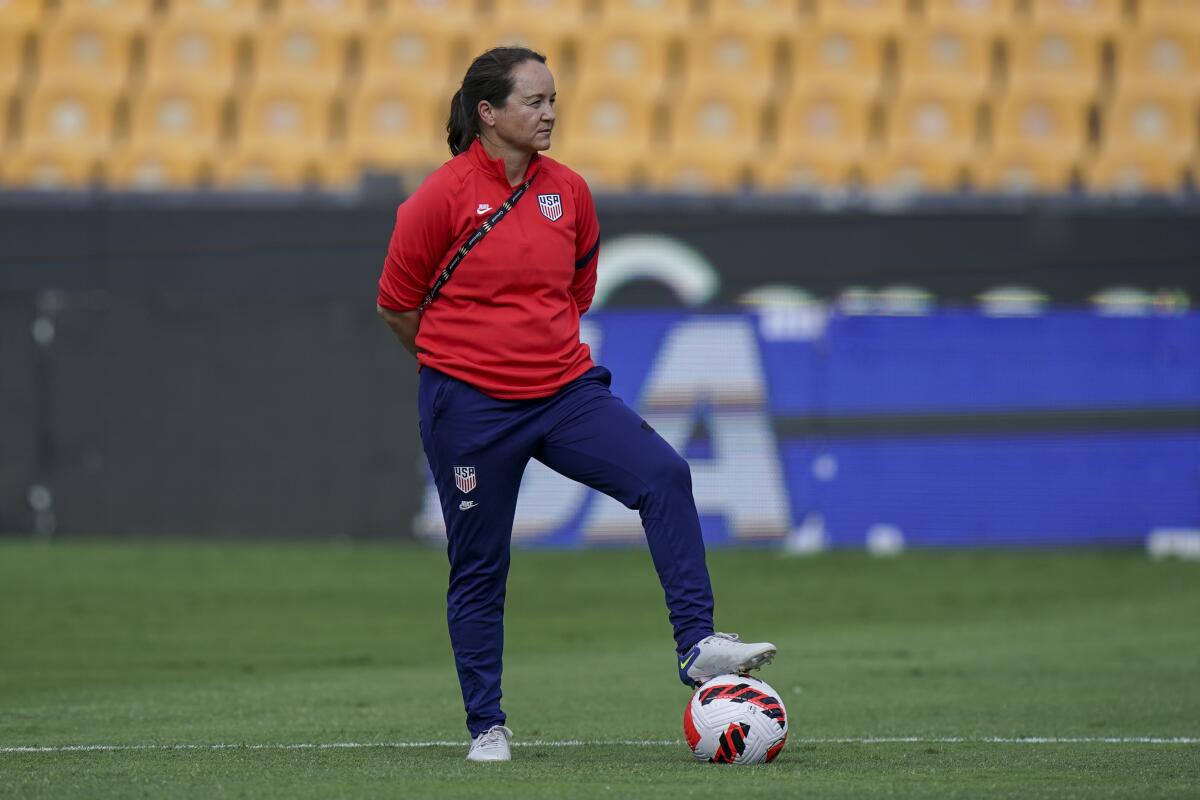 Twila Kilgore, U.S. women's national soccer team assistant coach stands with her foot on the ball.