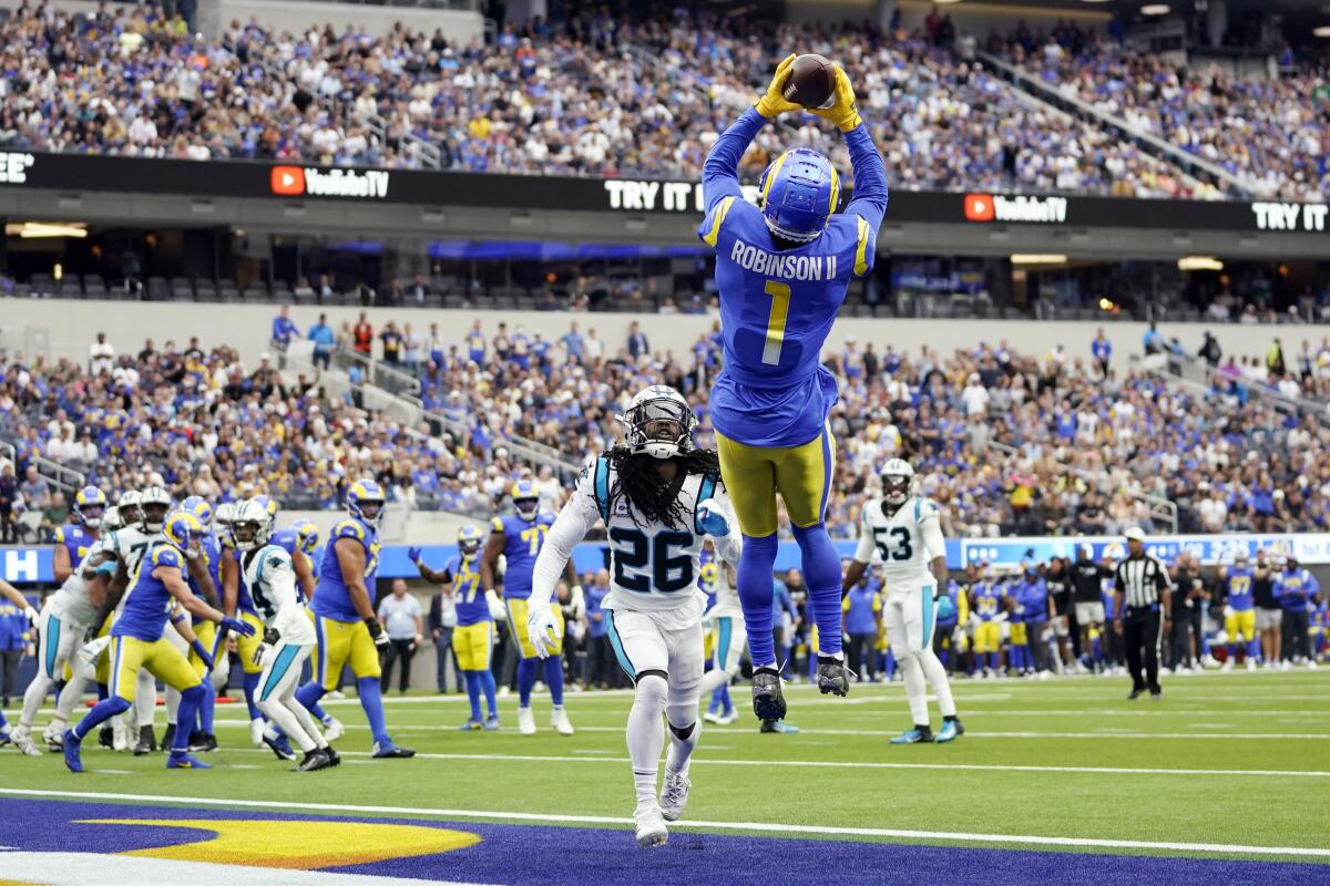 Rams receiver Allen Robinson II leaps and stretches to makes a touchdown catch in front of Panthers cornerback Donte Jackson 