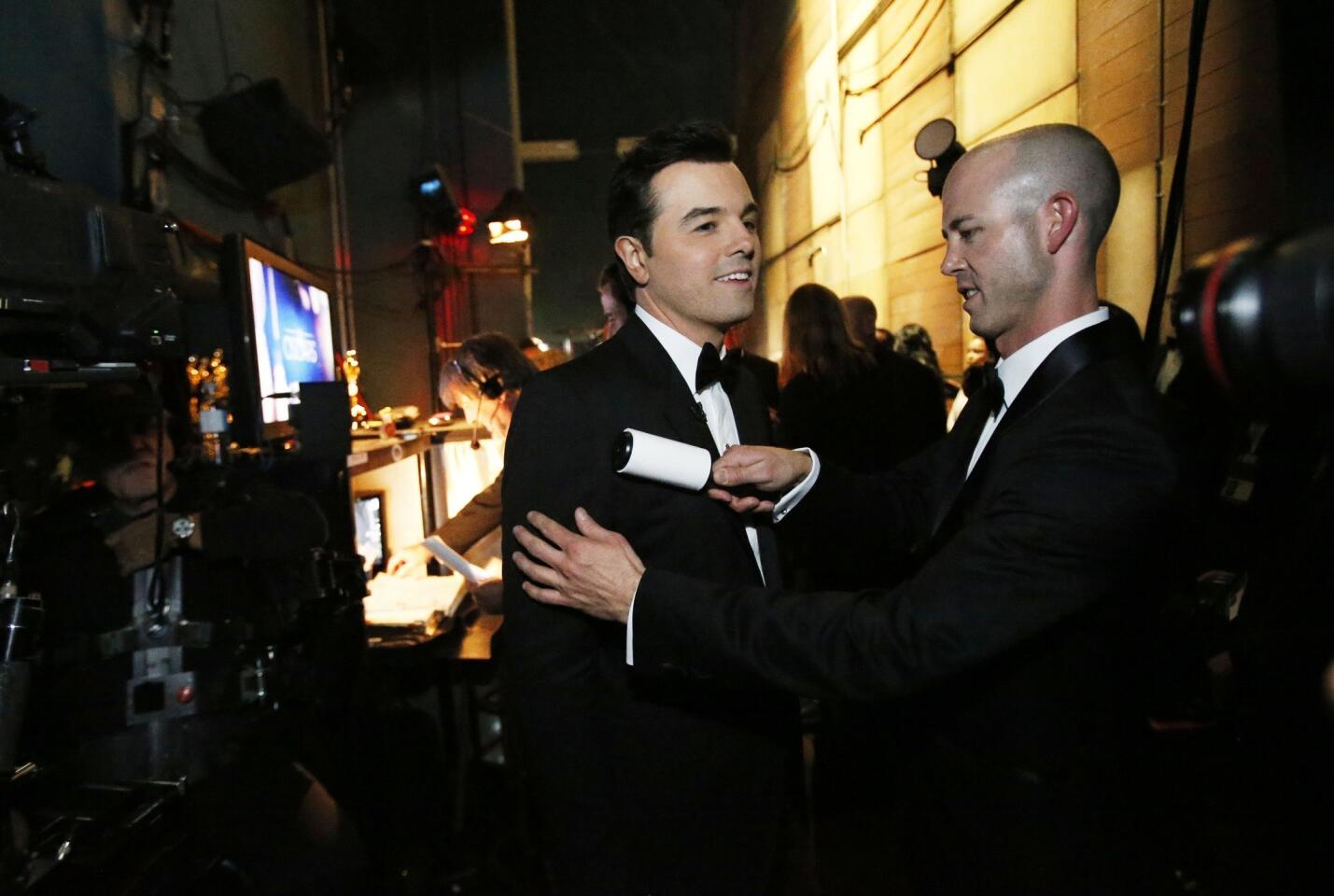 Seth MacFarlane brushes up backstage at the Oscars.
