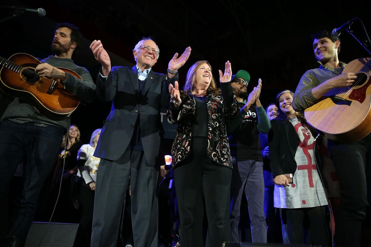 Bernie Sanders and his wife, Jane O'Meara Sanders, join musical guests on stage at a campaign event at the University of Iowa in Iowa City, two days before the state caucuses.