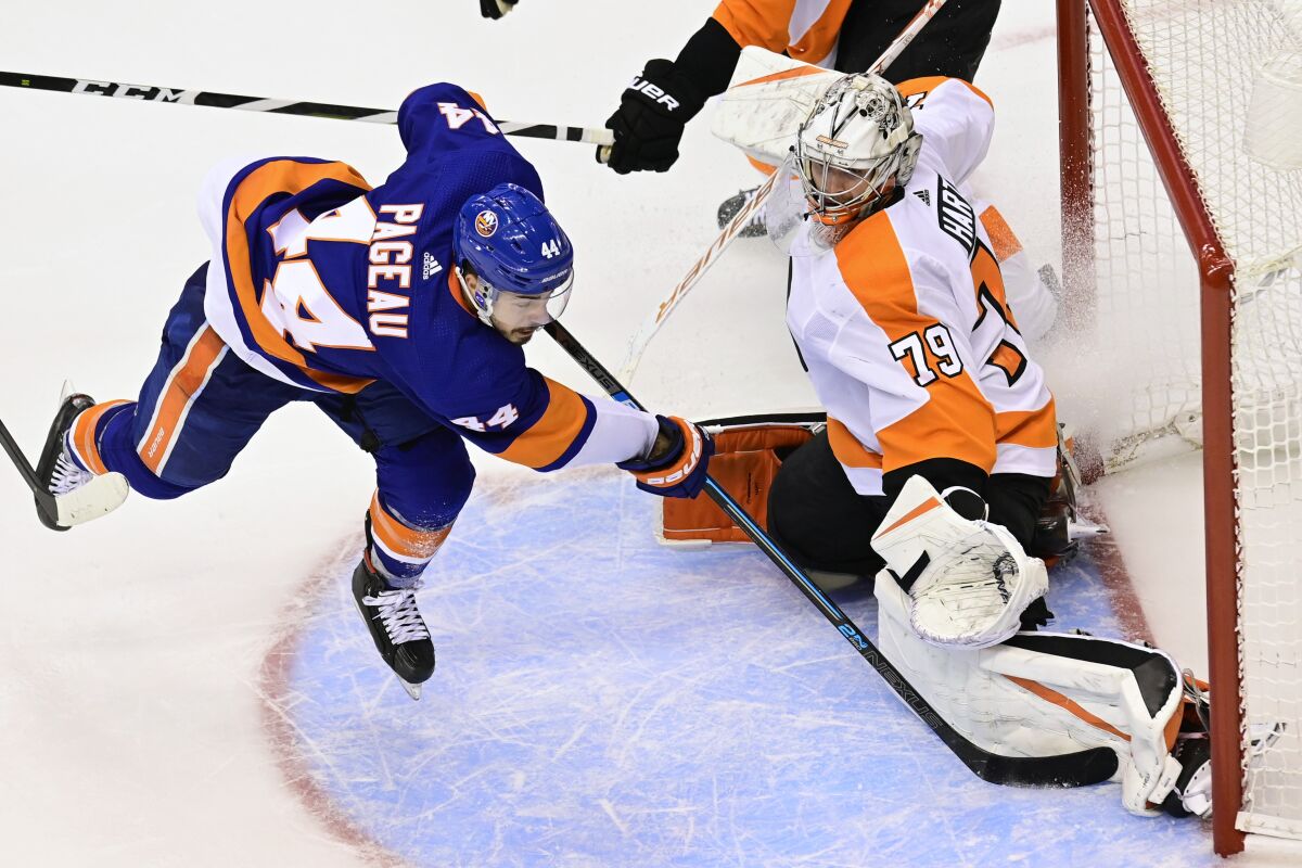 Philadelphia Flyers goaltender Carter Hart (79) stops New York Islanders center Jean-Gabriel Pageau (44) during overtime period NHL Stanley Cup Eastern Conference playoff hockey game action in Toronto, Thursday, Sept. 3, 2020. (Frank Gunn/The Canadian Press via AP)