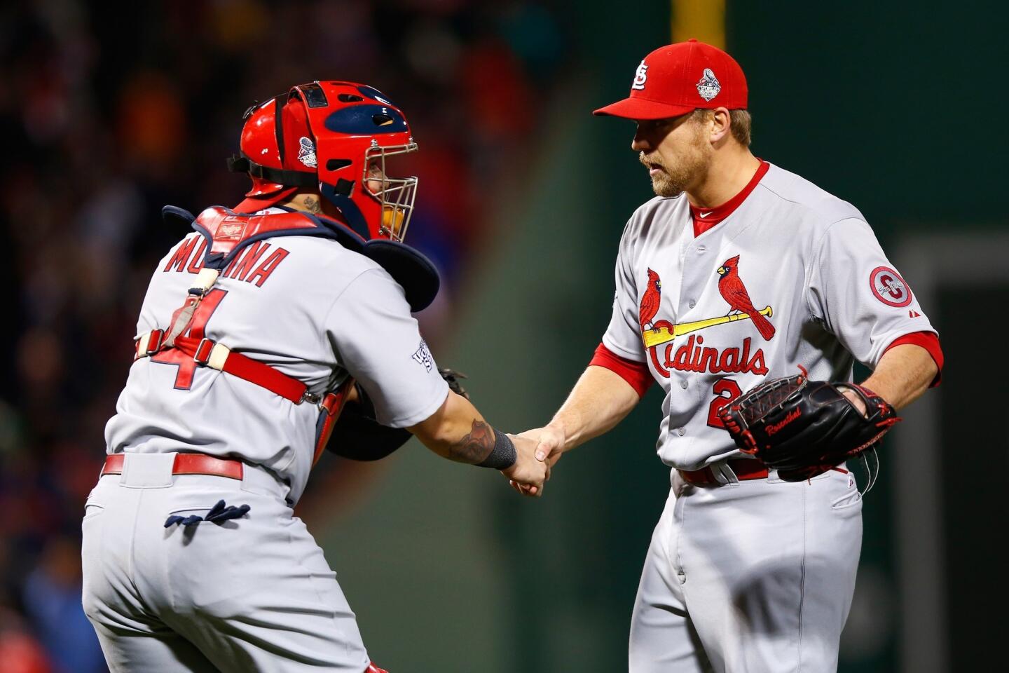 Cardinals catcher Yadier Molina congratulates closer Trevor Rosenthal after he worked a 1-2-3 ninth inning by striking out all three Red Sox.